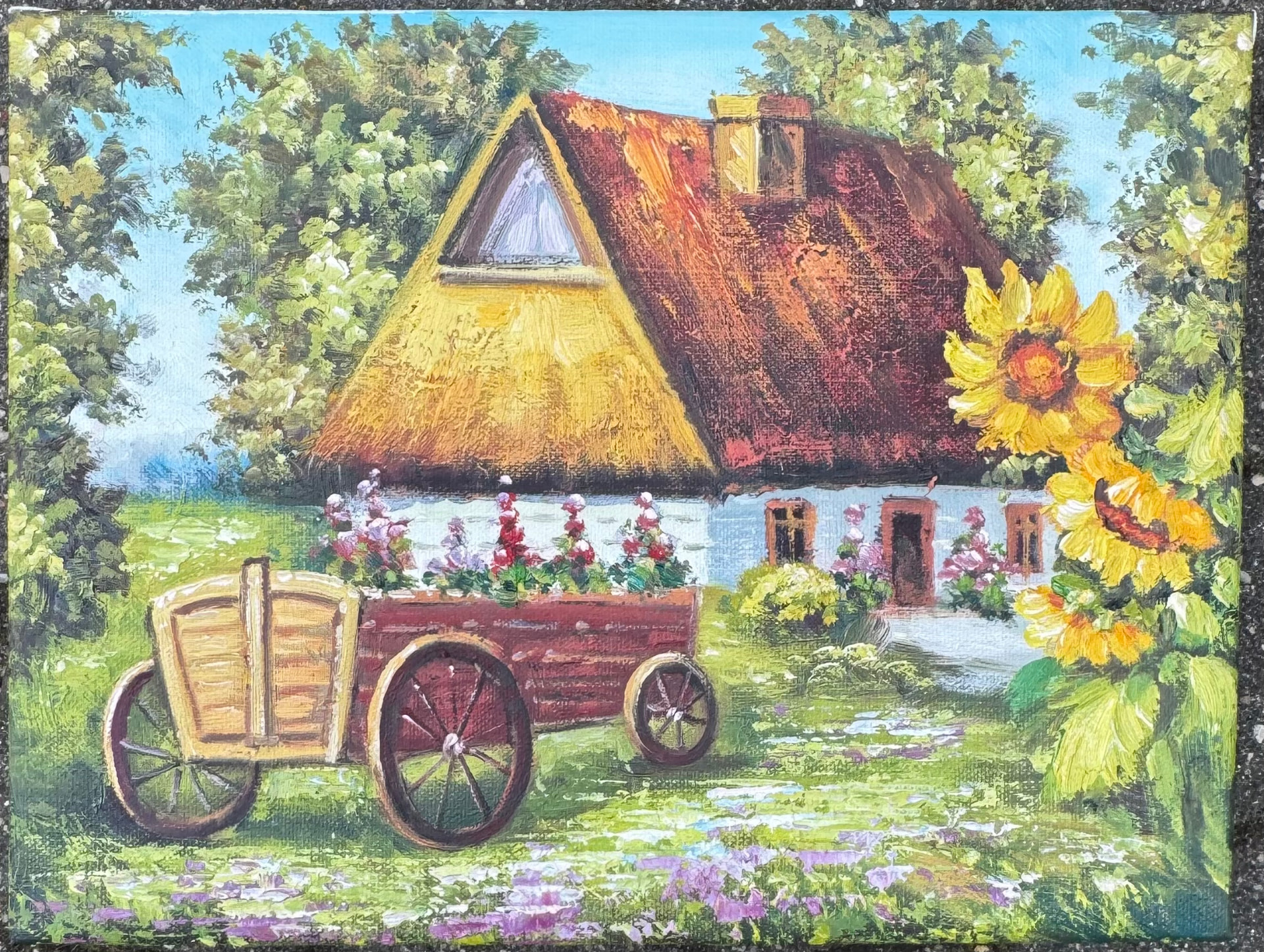 Wiejski domek ze słonecznikami